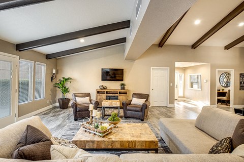 a living room with couches and chairs and a table